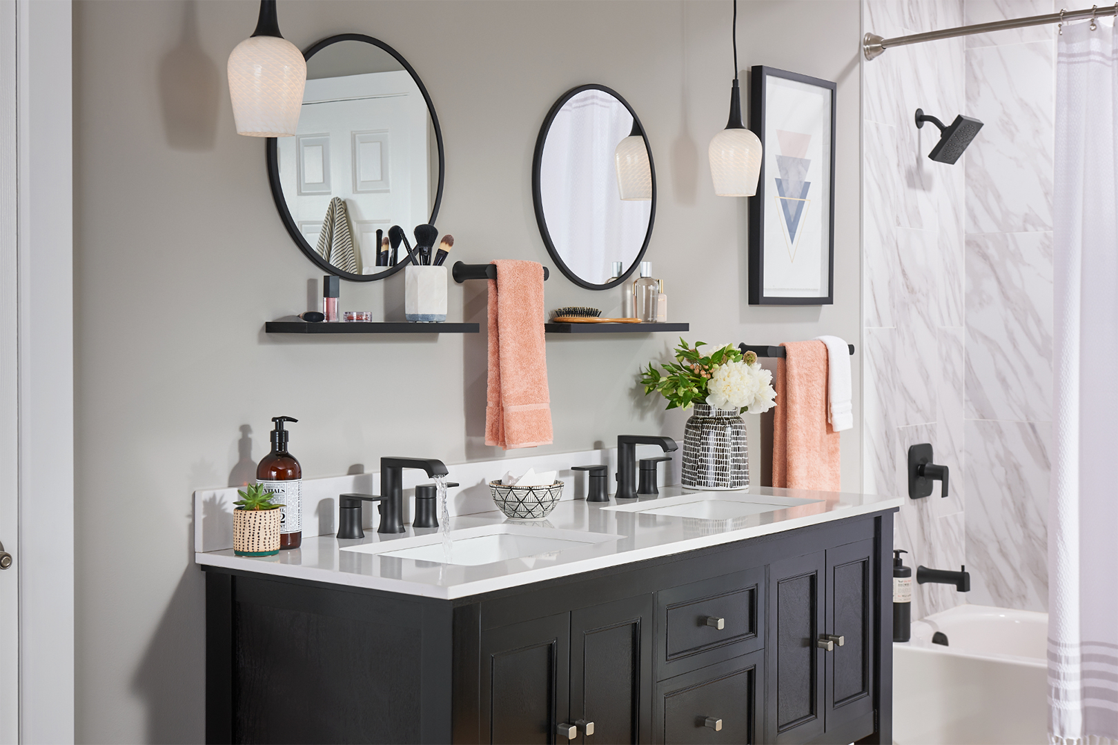 his and her sinks with matching round mirrors and matte black fixtures